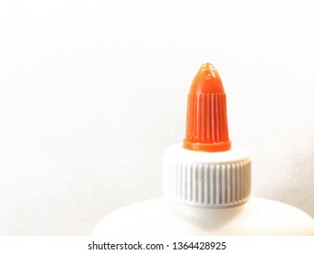 top of white school glue bottle on white background. Administrative Professionals Day, teacher appreciation, coworker, school, and hard work concepts