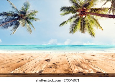 Top of wood table with blurred sea and coconut tree background - Empty ready for your product display montage. Concept of beach in summer - Powered by Shutterstock