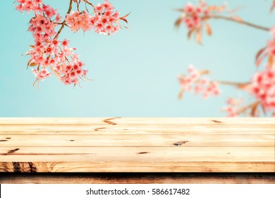 Top Of Wood Table Empty Ready For Your Product And Food Display Or Montage With Pink Cherry Blossom Flower (sakura) On Sky Background In Spring Season. Vintage Color Tone.