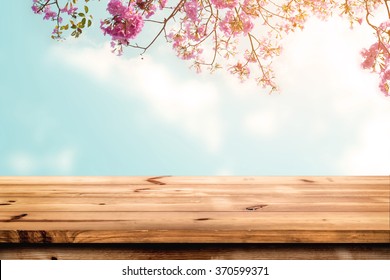 Top of wood table with pink cherry blossom flower on sky background - Empty ready for your product display or montage.  - Powered by Shutterstock