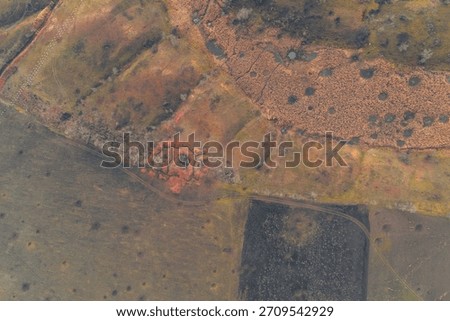 Top-down aerial view of a complex star-shaped defensive trench position and numerous shell craters in a combat zone.