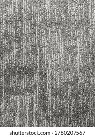 Top-down macro shot of gray loop pile carpet texture with white speckled patterns. High-quality tactile fabric background for interior design, office flooring, and minimalist home decor content. Clean, modern, and high-detail textile surface
