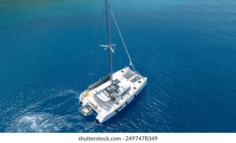 A top-down perspective of a catamaran gliding through the waves.