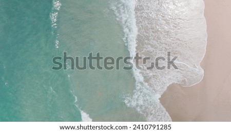 Top-down sandy beach sea wave rolling come in sand beach