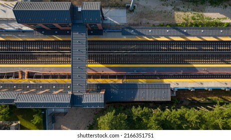 A top-down shot directly over an empty railroad train station on a sunny evening on Long Island. Taken with a drone camera.