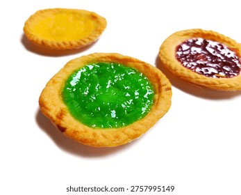 A top-down, slightly elevated perspective photograph featuring three small Indonesian milk tarts (Pai Susu) arranged in a triangular pattern against a clean, brilliant white background