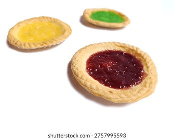 A top-down, slightly elevated perspective photograph featuring three small Indonesian milk tarts (Pai Susu) arranged in a triangular pattern against a clean, brilliant white background