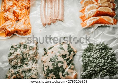 Top-down view of assorted marinated proteins arranged on a textured white surface. Visible items include orange-glazed shrimp, pale pink raw sausages, thinly