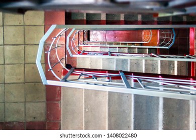 Top-Down View of Concrete Stairs, Metal Handrails in High-Rise Residential Building. Emergency Exit Concept.