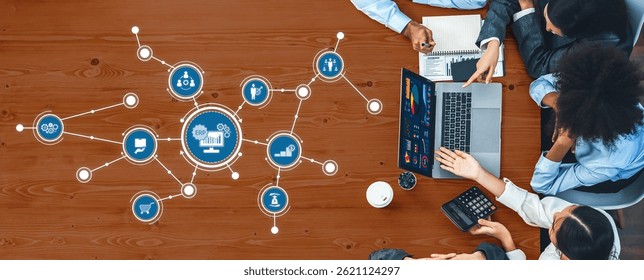 A top-down view of a diverse team engaged in a collaborative meeting, utilizing laptops and digital tools to analyze data and develop business strategies effectively. Amity