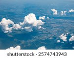 Top-down view of the earth through the clouds.