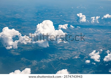Top-down view of the earth through the clouds.