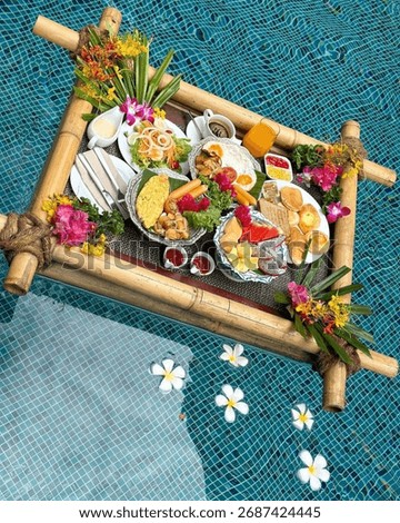Top-Down View of Floating Breakfast Tray in Swimming Pool with Fruits and Flowers
