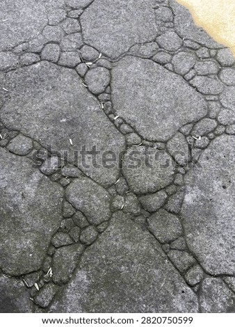 Topdown view of irregular grey stone pavement background texture with natural joints.
