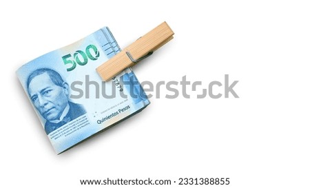 Top-down view of an isolated bundle of bills tied with a paperclip on a white background. Mexican pesos. super peso