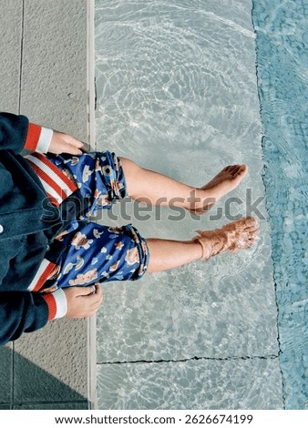 Top-down view of a joyfula boy playing on the swimming pool
