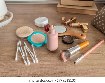 Top-down view of makeup essentials like foundation, lipstick, and brushes on a wooden surface, ready for a morning beauty routine.