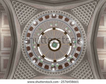 A top-down view of a mosque dome showcasing intricate Islamic art and geometric patterns. The design includes a central chandelier surrounded by symmetrical details, arches, and decorative motifs.