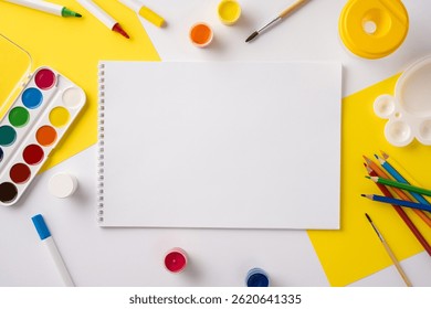 Top-down view of a notebook surrounded by colorful school supplies and art materials