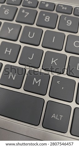 Top-down view of a QWERTY computer keyboard, technology infrastructure, remote work, and digital communication concept.