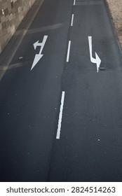 Top-down view of a road marked with left and right directional arrows, symbolizing navigation, choice, traffic guidance, transportation, decision making, and route planning.