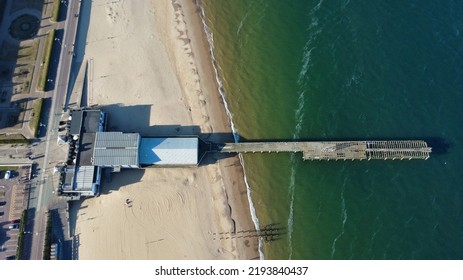 Top-down View Of A Seaside Pier During Summer