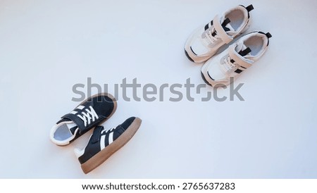 A top-down view showcases two distinct styles of children's footwear, highlighting their design elements and color contrast against a neutral surface
