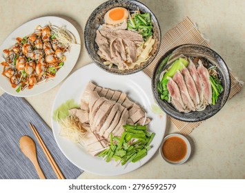 A top-down view of a table laden with various delicious Asian food dishes, ready to be enjoyed.