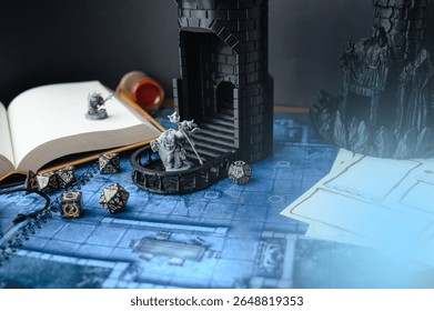 Top-down view of a tabletop RPG setup with dice, miniatures, character sheets, a dice tower, and a fantasy map. Perfect for DnD, strategy games, or role-playing visuals.	
