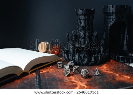 Top-down view of a tabletop RPG setup with dice, miniatures, character sheets, a dice tower, and a fantasy map. Perfect for DnD, strategy games, or role-playing visuals.	
