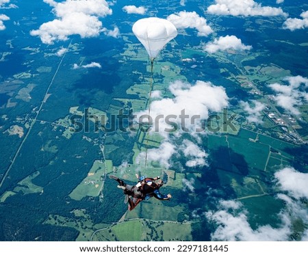 Top-down view of tandem skydive pair enjoying the view over rural Virginia fields