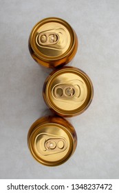 Top-down View Of Three Cans Of Ginger Beer Isolated On A Light Background