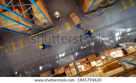 Top-Down View: In Warehouse People Working, Forklift Truck Operator Lifts Pallet with Cardboard Box. Logistics, Distribution Center with Products Ready for Global Shipment, Customer Delivery