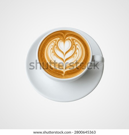 Top-down view of a white cup of coffee with elaborate latte on a saucer