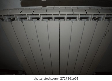 Top-down view of a white panel convector electric radiator mounted on a wall, featuring slim vertical fins and slim top grille for efficient convection heating. Neutral gray finish blends seamlessly with modern interiors, subtle control label visible. Essential for cozy home warmth and energy-efficient room heating.

