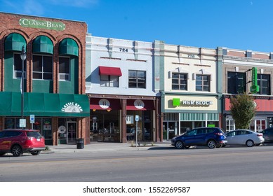 Topeka, Kansas / United States of America - November 2nd 2019 : Downtown Topeka storefronts.  Brick buildings with parking out front.  H&R Block, Classic Bean, Hazel Hill Chocolate.