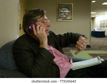 Topeka Kansas, USA, 4th November,  2014
Thomas Frank Reporter And Author Checking The Time For His Next Interview Over The Phone For A Cable TV Show Covering Election Night In Topeka Kansas.
