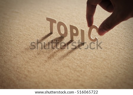 TOPIC word of wood alphabet with shadow on cork board,compressed board