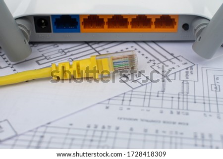 Topical Internet and Network Technology: Back view of a Wireless Internet Router modem and network cable over topological network map. concept of technological services, networks and internet service