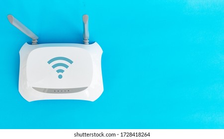Topical networking and Internet technology: top view Wireless Router modem on blue background with copy space. concept of technological services, networks and internet service.