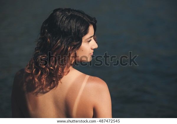 Topless Bikini Model Woman with\
Tan Lines on the Beach in the Water at a Lake Beach in\
California