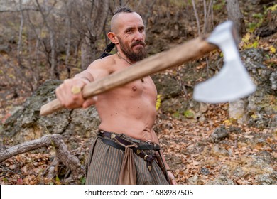 Topless Viking Holding A Battle Ax In His Hand