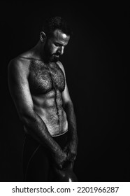 Topless Young Jewish Man Carrying Dumbbell Showing His Upper Body Muscles In A Black And White Theme