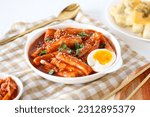 Topokki or tteokbokki with boiled egg on a white plate. perfect for recipe, article, catalogue, commercial, or any cooking contents. 