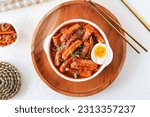 topokki or tteokbokki with boiled egg on a white plate. flat lay angle.  perfect for recipe, article, catalogue, commercial, or any cooking contents.