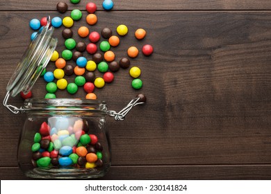 topple over glass jar full of colorful sweets