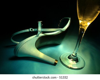 A toppled high heel and a champagne flute.