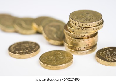 A a toppled pile of pound coins on a table.