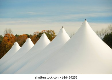 The Tops Of A Series Of Party Tents Set Up For A Commercial Sales Event.