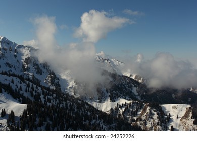 Tops of snow mountains in clouds